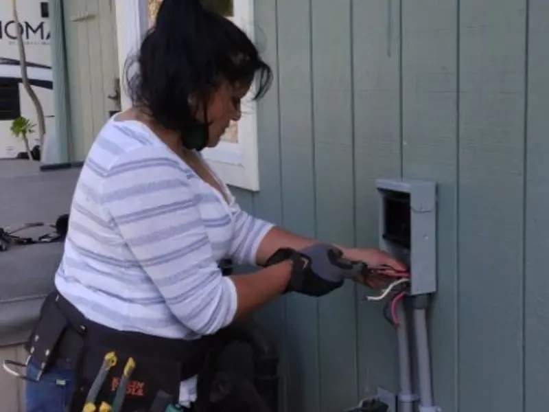 Licensed electrician wiring an exterior subpanel in St. Clair